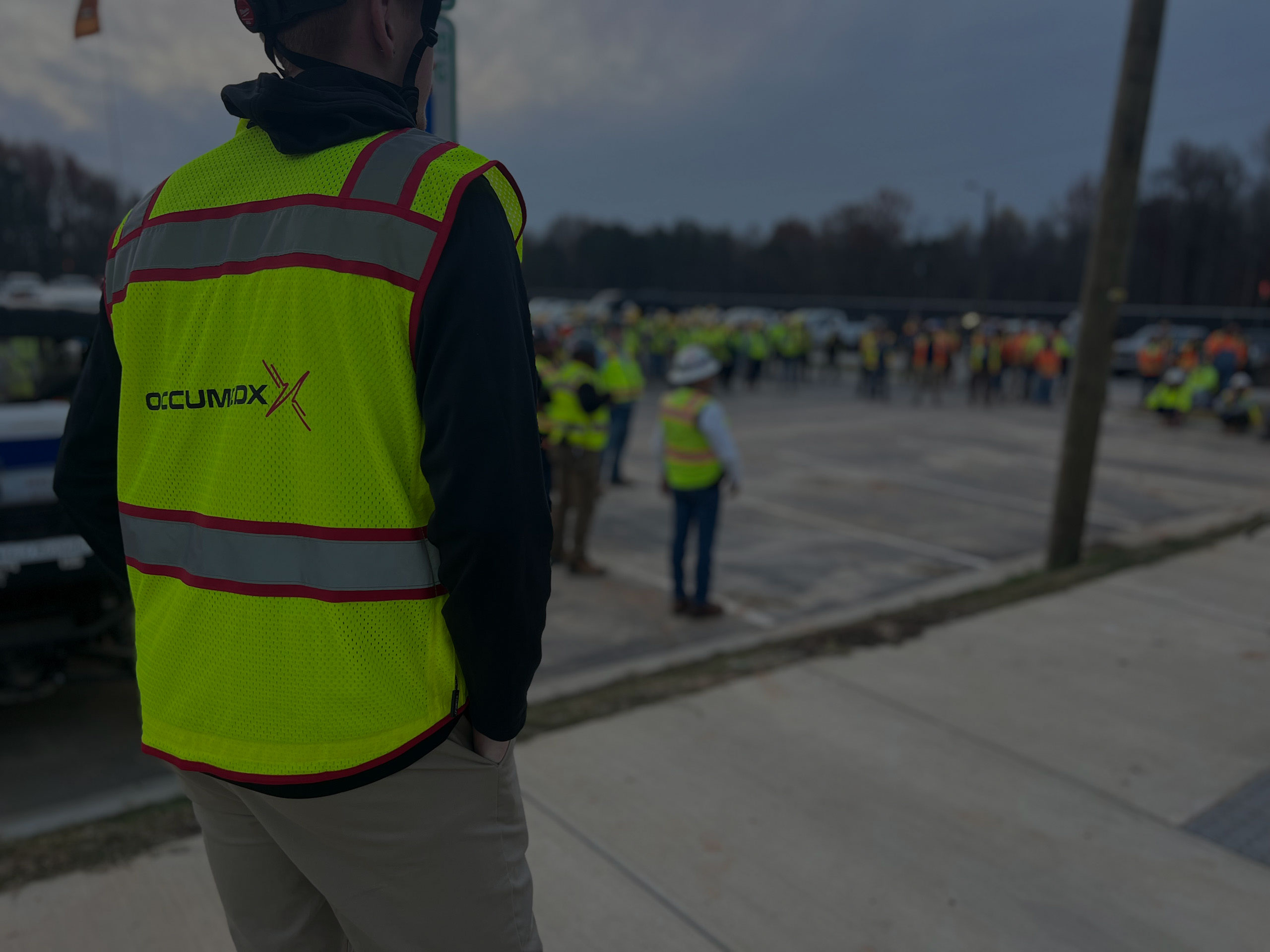 OccuMedX employee overseeing a large group of workers outdoors during a mobile health solutions event in Charlotte, NC